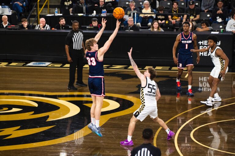 Sophomore TJ Nadeau tees up a three in UDM's 95-89 win over Oakland